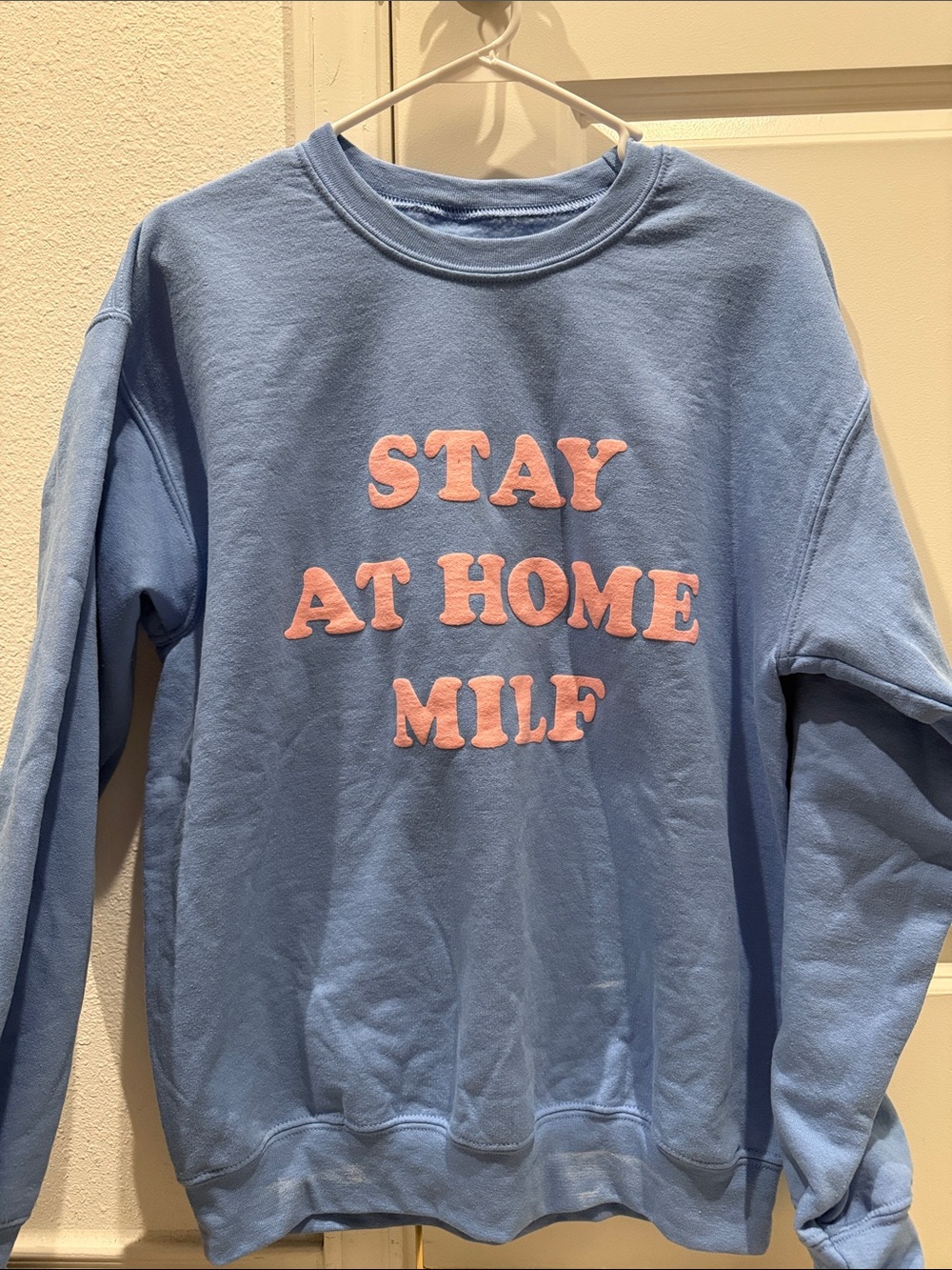 Light Blue Crewneck Sweatshirt with Pink Lettering